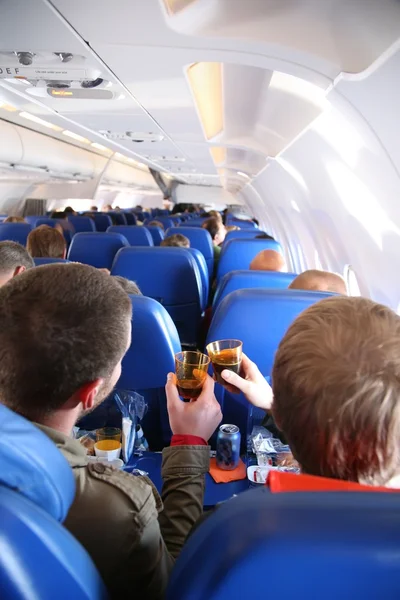 Passengers in the aircraft from behind — Stock Photo, Image