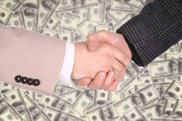 Handshaking op dollar achtergrond — Stockfoto