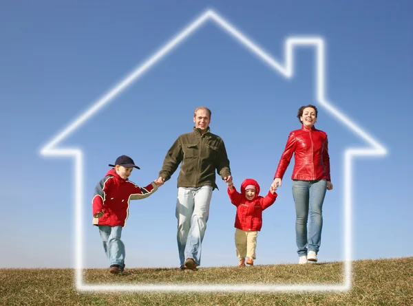 Running family of four in dream house — Stock Photo, Image
