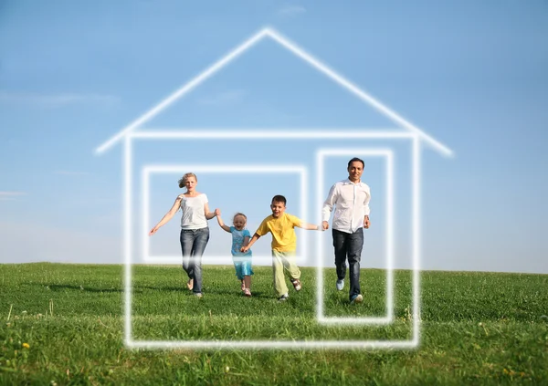 Family of four running to dream house — Stock Photo, Image