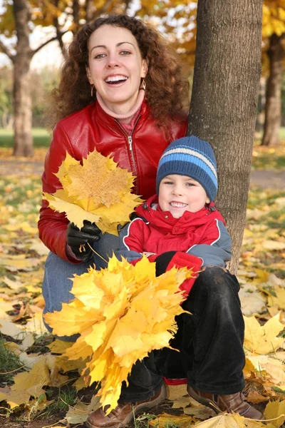Mutter mit Sohn im Herbst im Park mit gelben Blättern 2 — Stockfoto