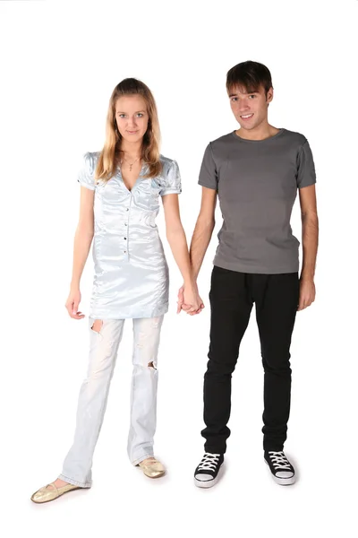 Teenager couple is held for the hands on the the white — Stock Photo, Image