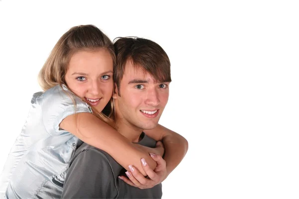 Dívka objímá chlapce zpět na bílém pozadí — Stock fotografie