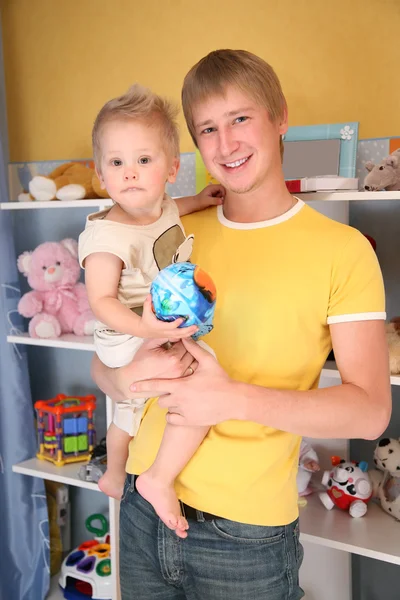 Father holds child on hands in playroom — Stock Photo, Image