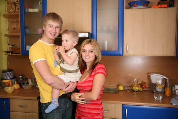 Родители и ребенок на руках на кухне 2 — стоковое фото