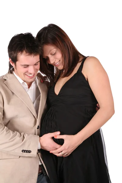Беременная пара трогает живот — стоковое фото