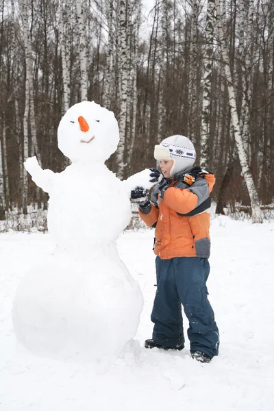 Niño hace muñeco de nieve —  Fotos de Stock