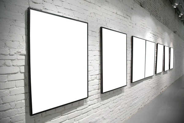 Frames on brick white wall — Stock Photo, Image