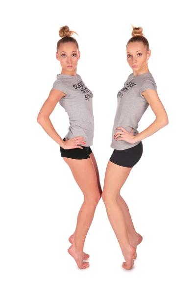 Twin sport girls stands on tiptoe face-to-face — Stock Photo, Image
