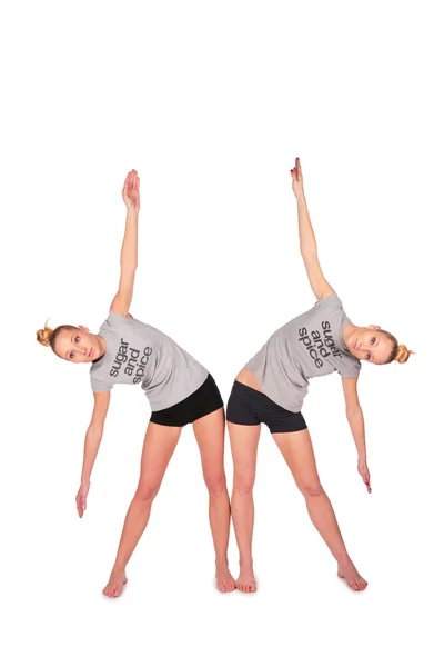 Twin sport girls side bend — Stock Photo, Image