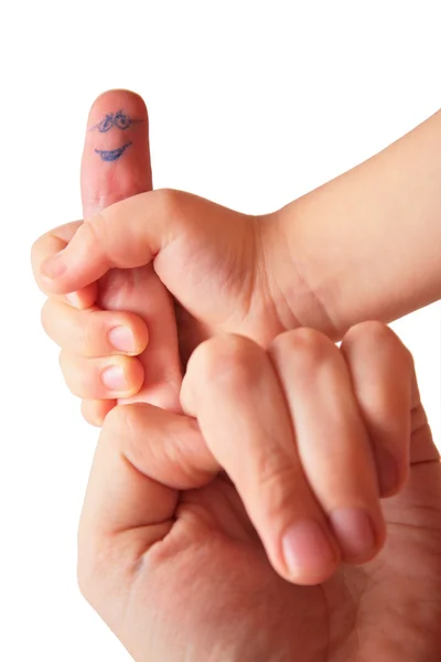 Children's hand houdt vinger met getekende gezicht — Stockfoto