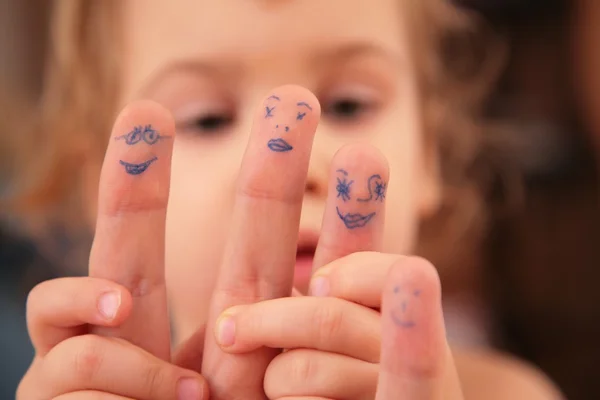 Child holds hand with drawn persons — Stock Photo, Image