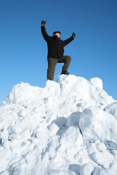 Elderly man on top of snow hill with hand up — Stock Photo, Image
