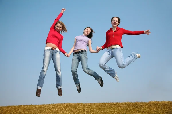 Drei springende Mädchen lizenzfreie Stockfotos