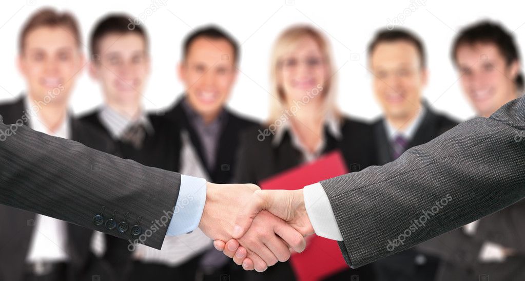 Shaking hands with wrists and six business group out of focus co