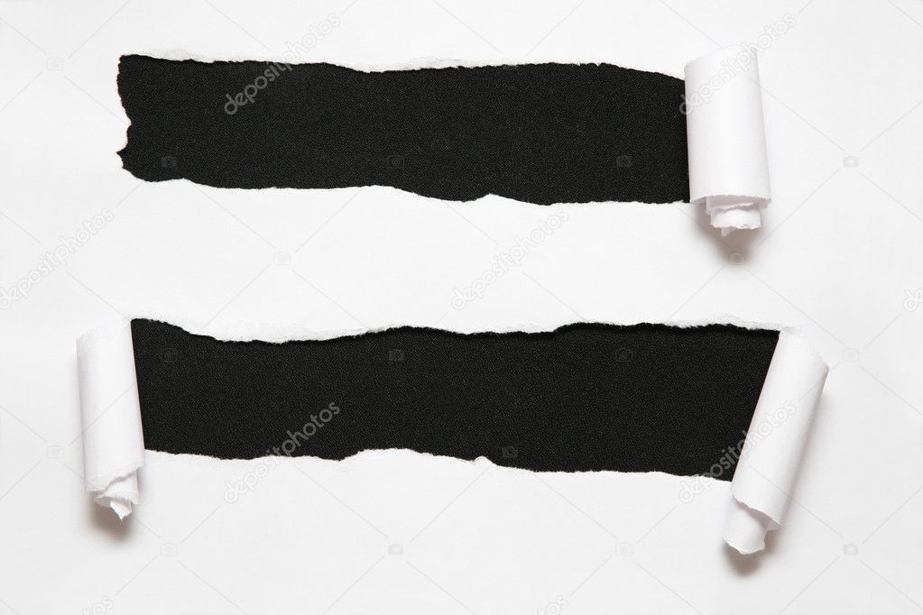 The sheet of paper with two holes against the black background