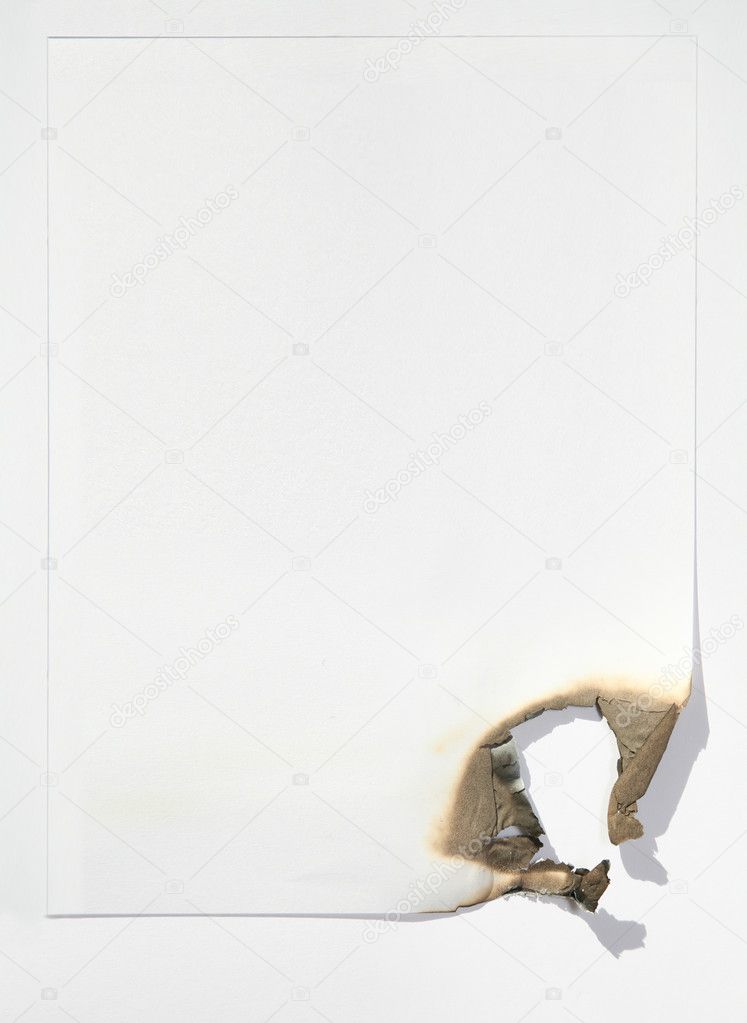 The sheet of paper by the burned edge against the white background