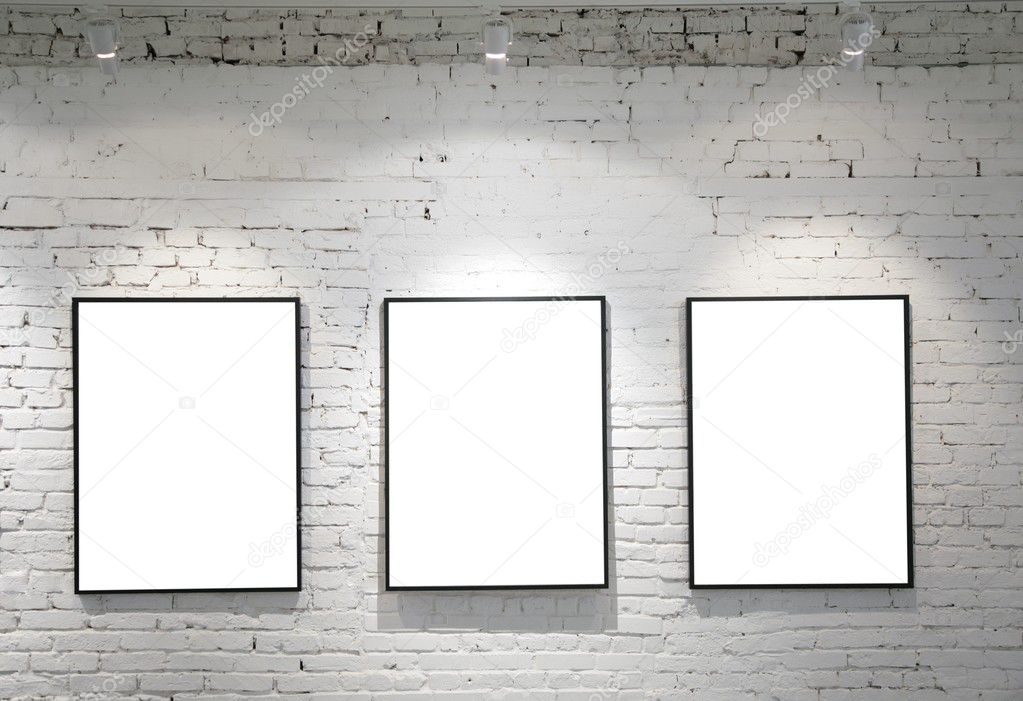 Three frames on brick wall