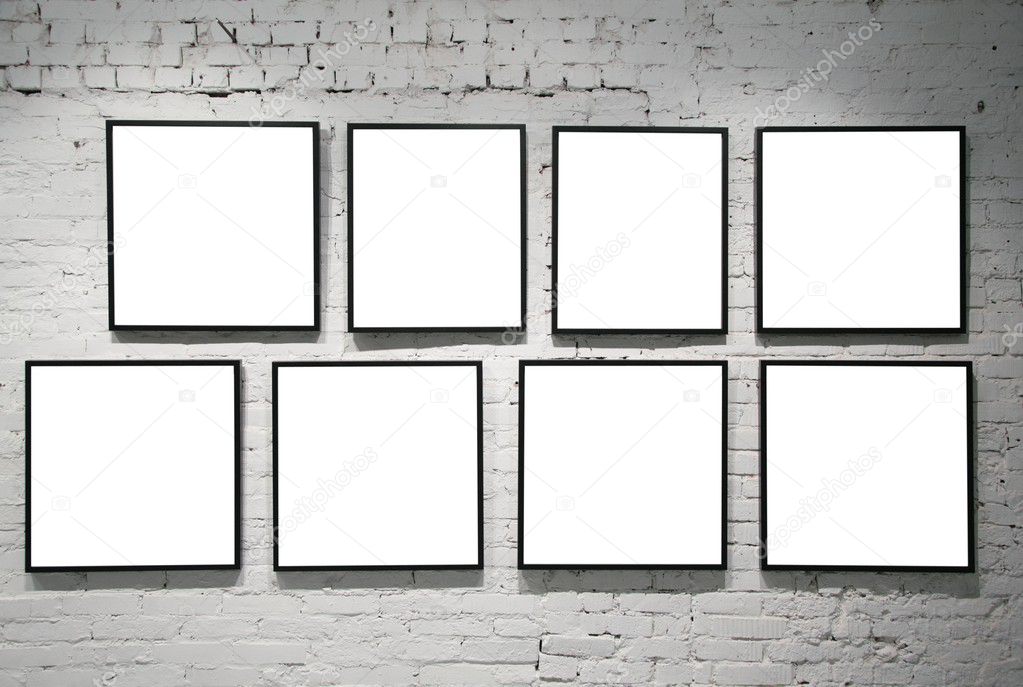 Frames on white brick wall