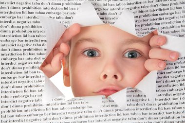 Boy looks into the hole in the sheet of paper with the text clipart