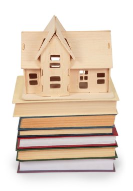 Toy house on pile of books clipart