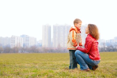 Mother and son look on each other outdoor clipart