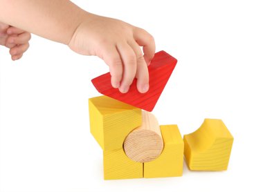 Children's hand holds cube clipart