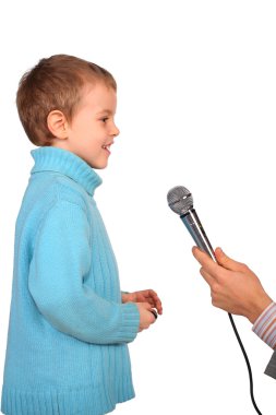 Boy speaks into microphone clipart