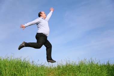 Fat man jumps on meadow clipart