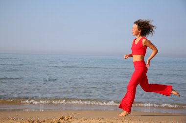 Fitness woman on beach clipart