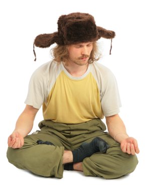 Cap kulak-flep ile uzun saçlı Rus adam meditasyon