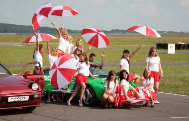 Paddock-girls with umbrellas on a racing line clipart