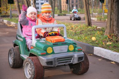 Children in toy car clipart