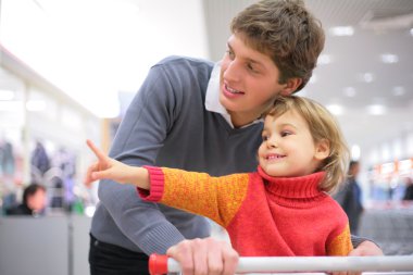 Father with child in shop clipart