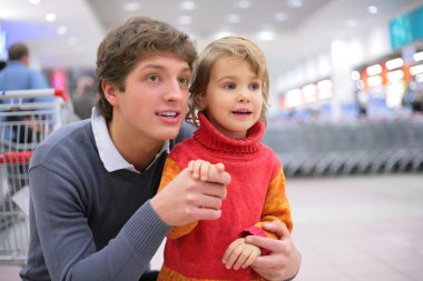 Father and daughter in supermarket clipart