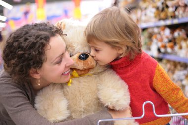 Mother with daughter and soft toy clipart