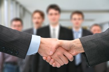 Shaking hands and business team clipart