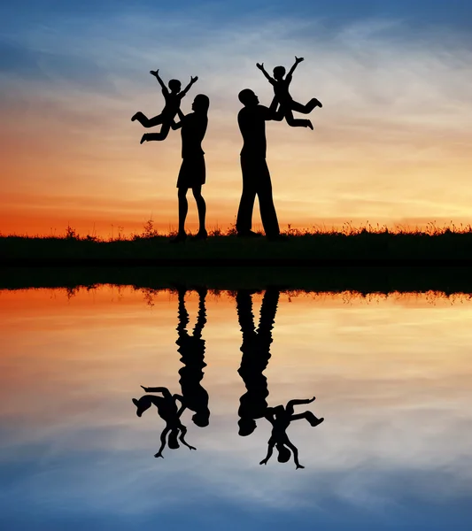 Family with children on hands silhouette — Stock Photo, Image