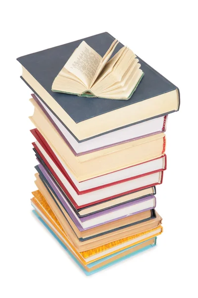 Big stack of books and opened small book — Stock Photo, Image
