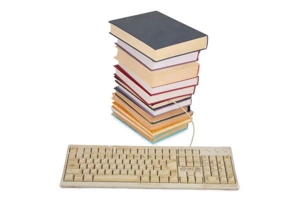 Stack of books with a connected white old dirty keyboard — Stock Photo, Image
