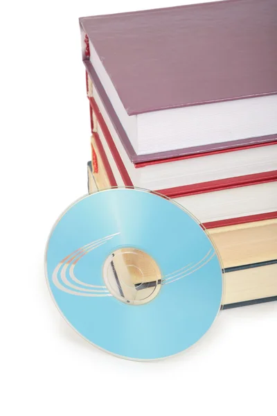 Cd-rom disk and pile of books — Stock Photo, Image