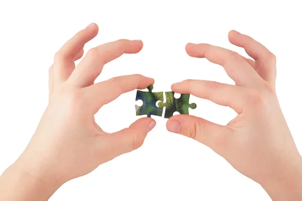 Two hands with puzzle — Stock Photo, Image