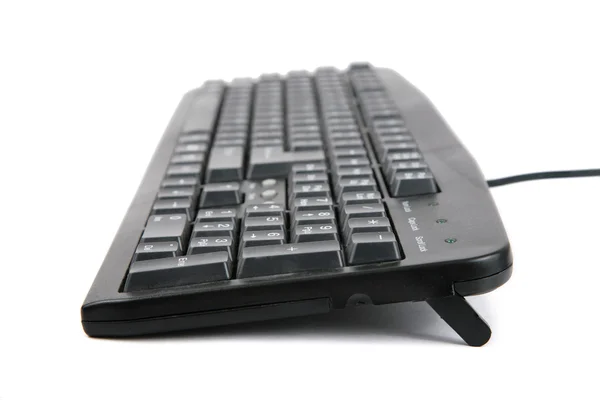 Schwarze schmutzige Tastatur auf der Seite — Stockfoto