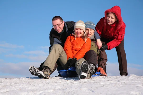 Two friends push two of others on sleighs — Stock Photo, Image