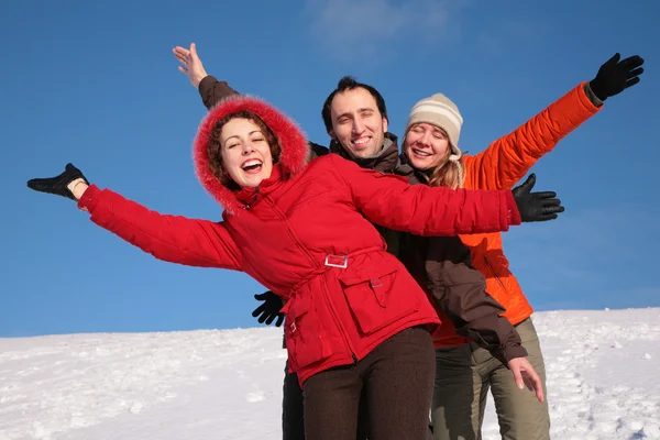 Group of friends move by hands in winter on hillside — Stock Photo, Image