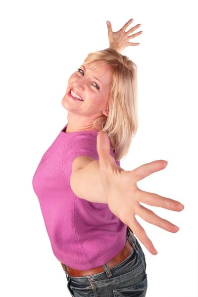 Middleaged woman in pink shirt stands dancing 2 — Stock Photo, Image