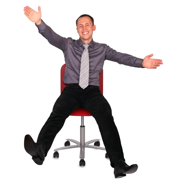 Mladý muž v kancelářská židle — Stock fotografie