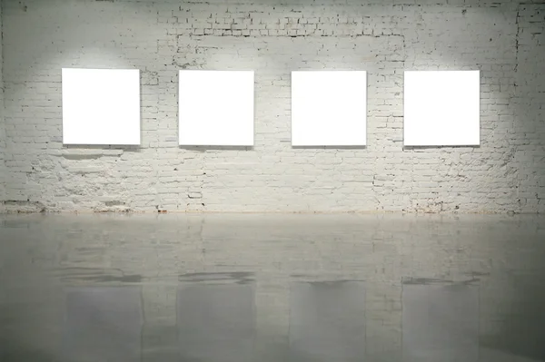 Frames on white brick wall — Stock Photo, Image