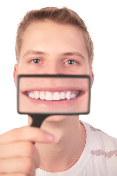 Man shows smile through magnifier — Stock Photo, Image