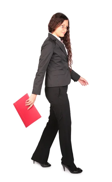 Beautiful brown-haired woman goes with red folder — Stock Photo, Image
